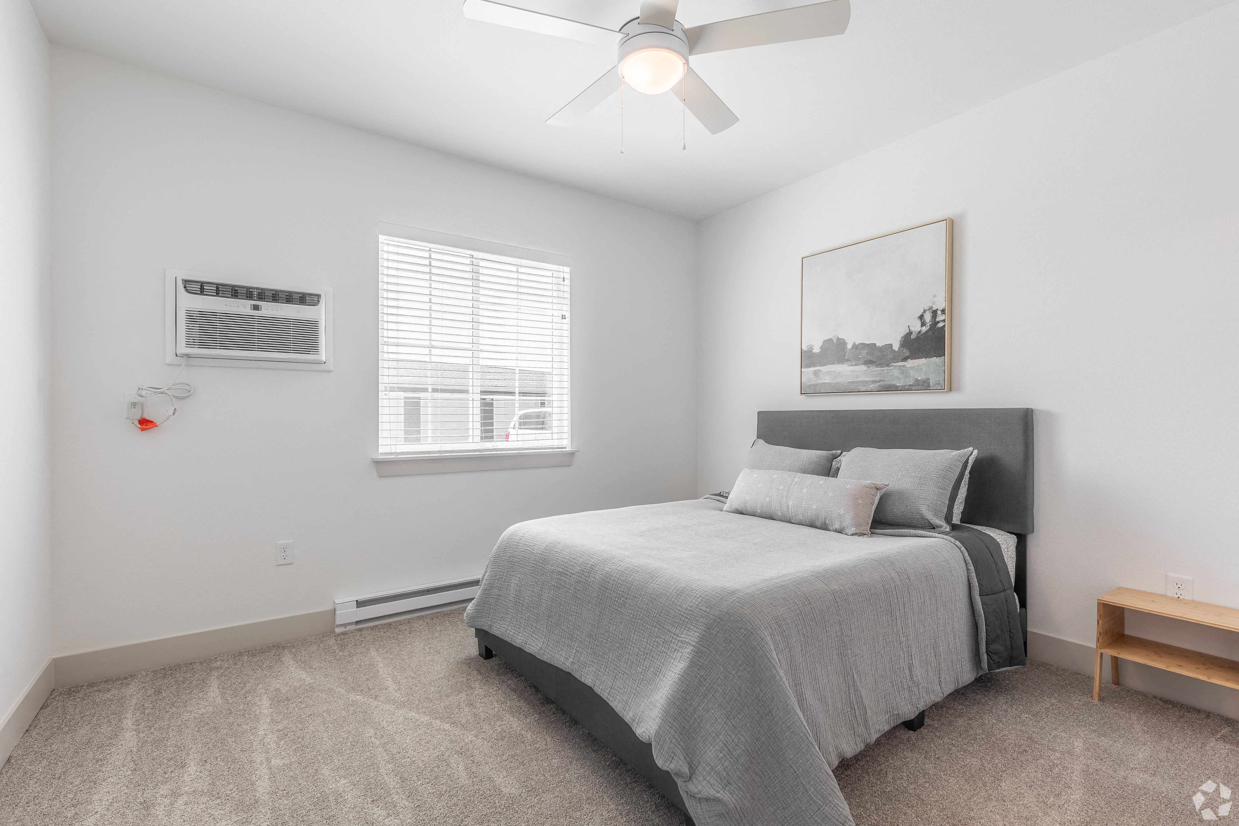 a bedroom with a bed and a ceiling fan