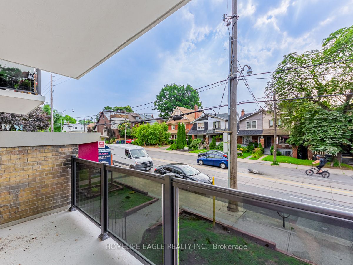 a view from a balcony of a street with cars