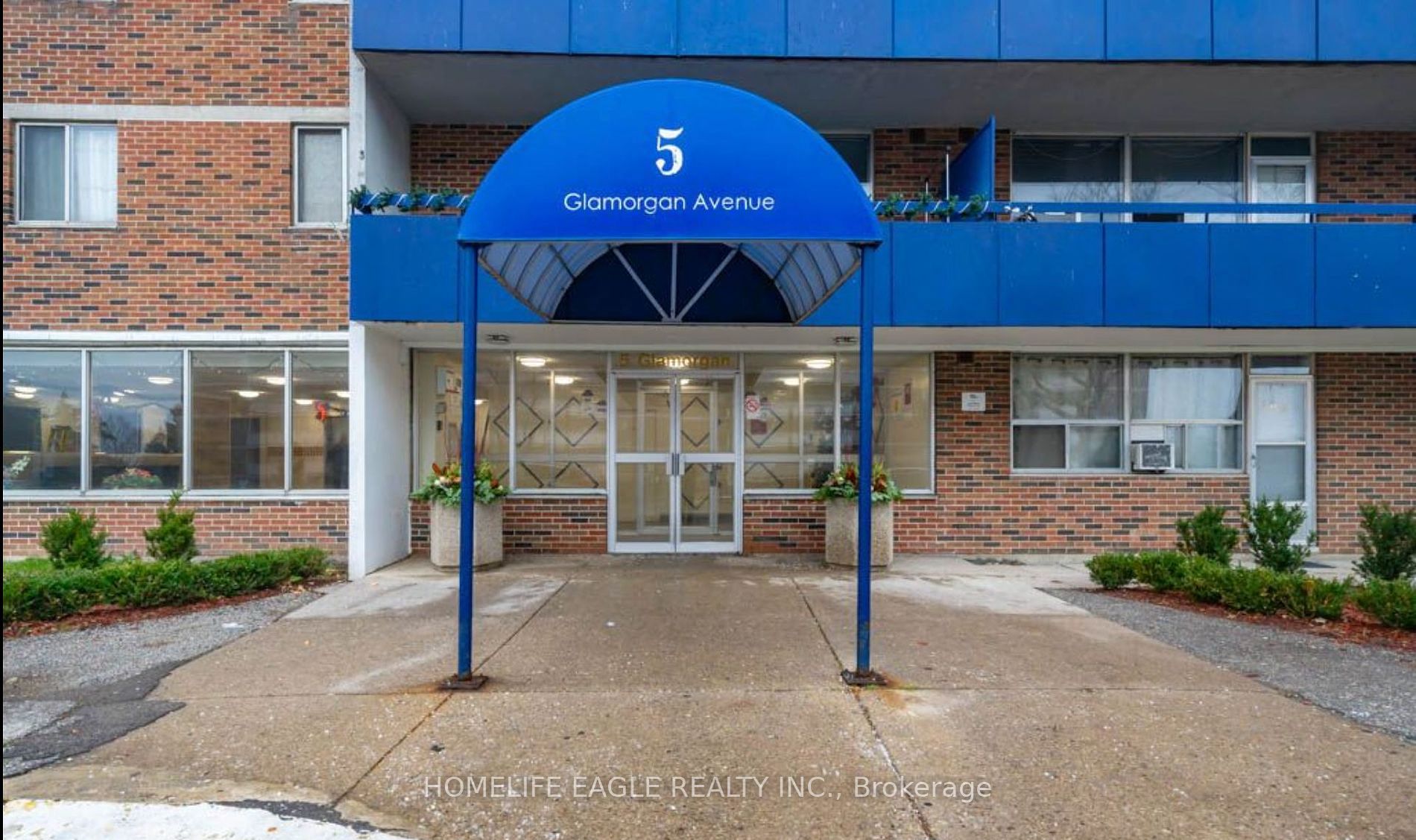 the front entrance of a building with a blue archway