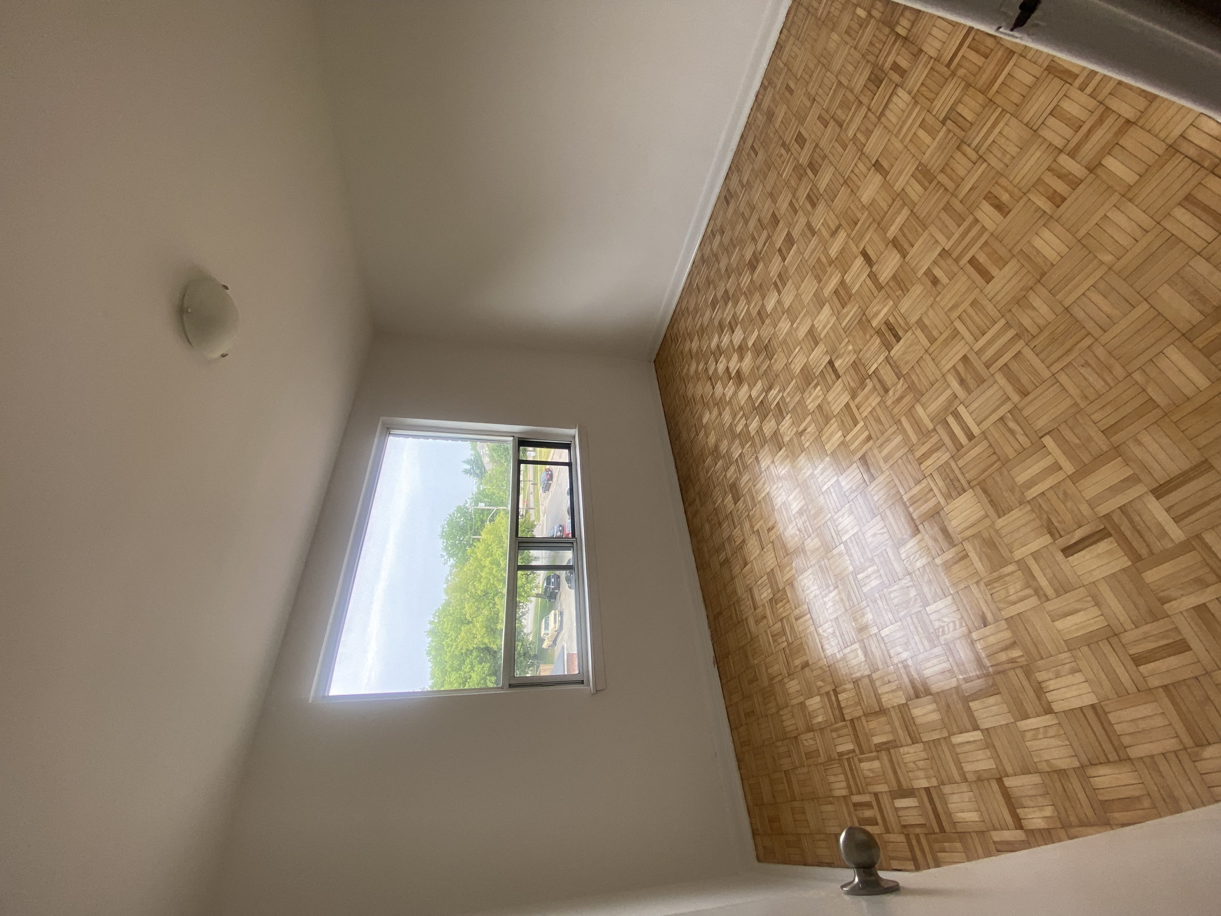 a small window in a room with a high ceiling