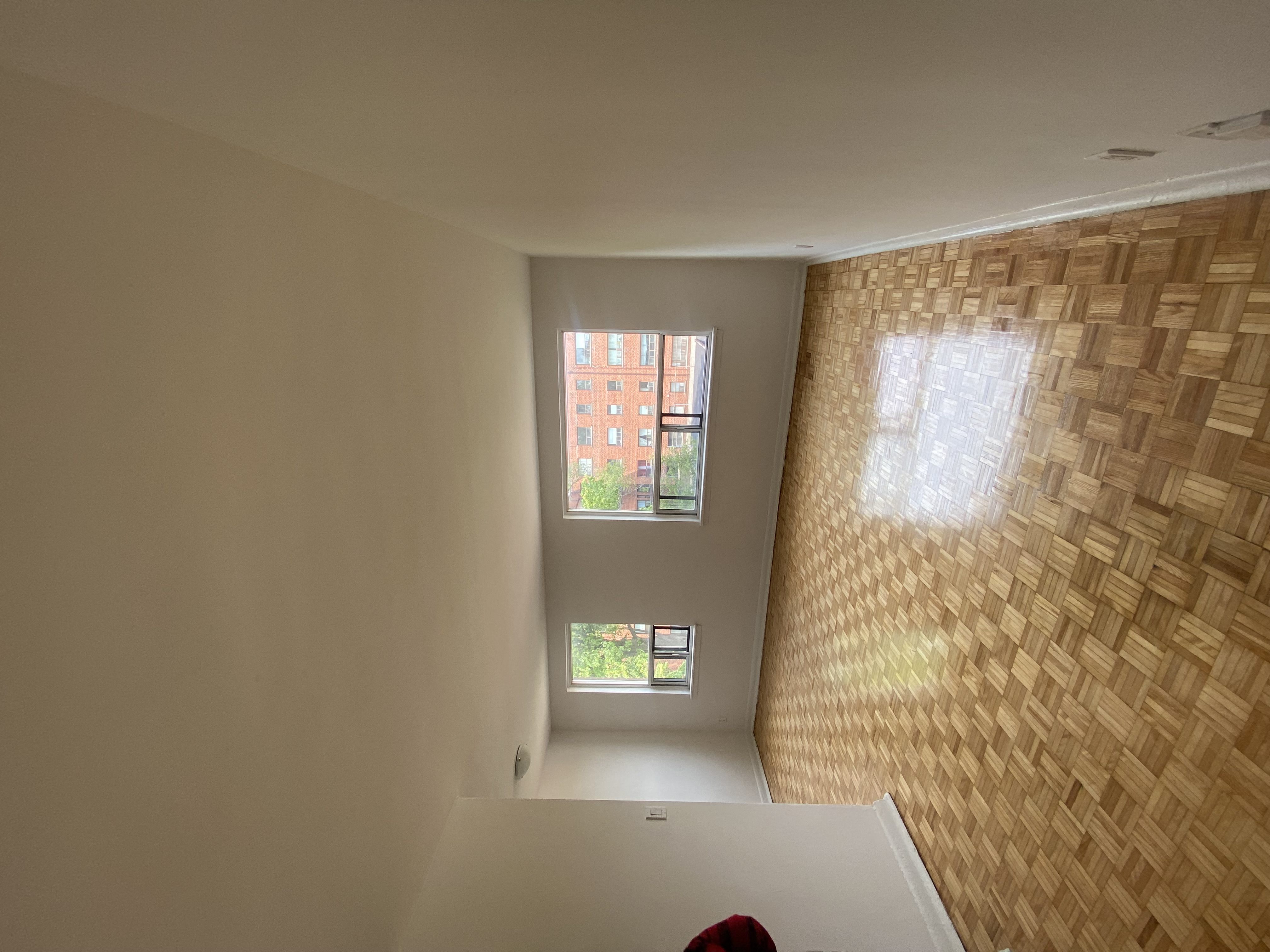 a view from the top of the stairs looking down into the bedroom