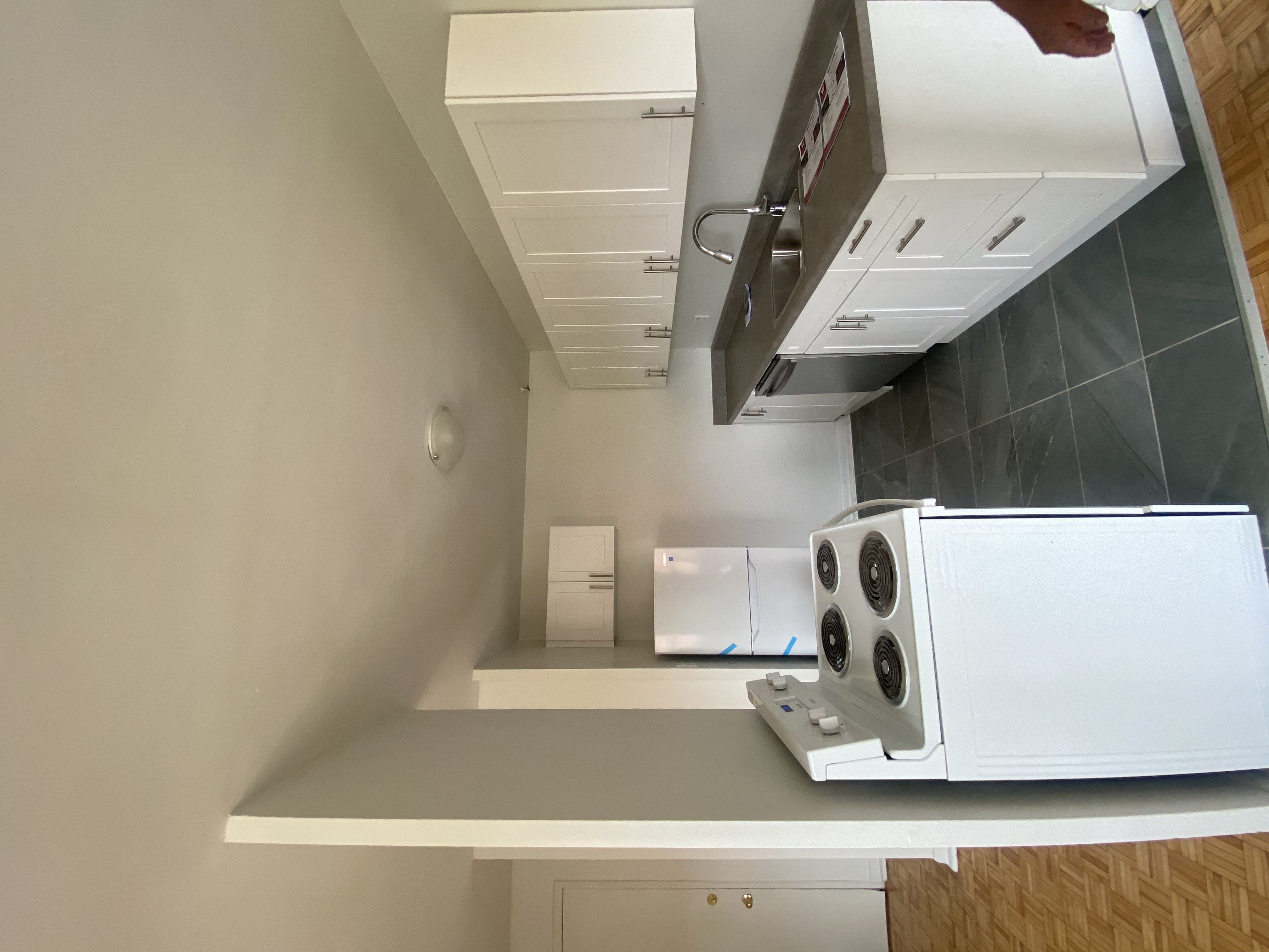 a kitchen with a stove top oven and a microwave