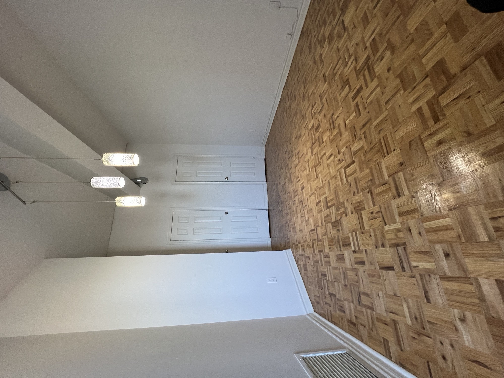 a view down a hallway with a white table and a wood wall