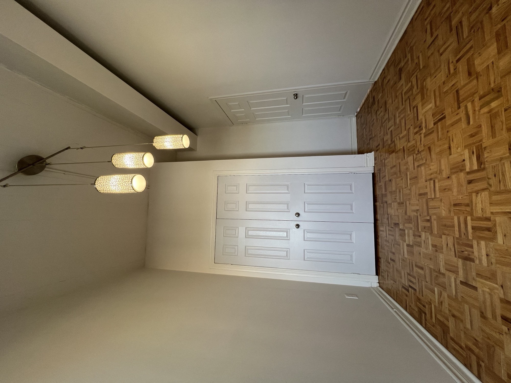 a garage door in a home with a wood paneled wall
