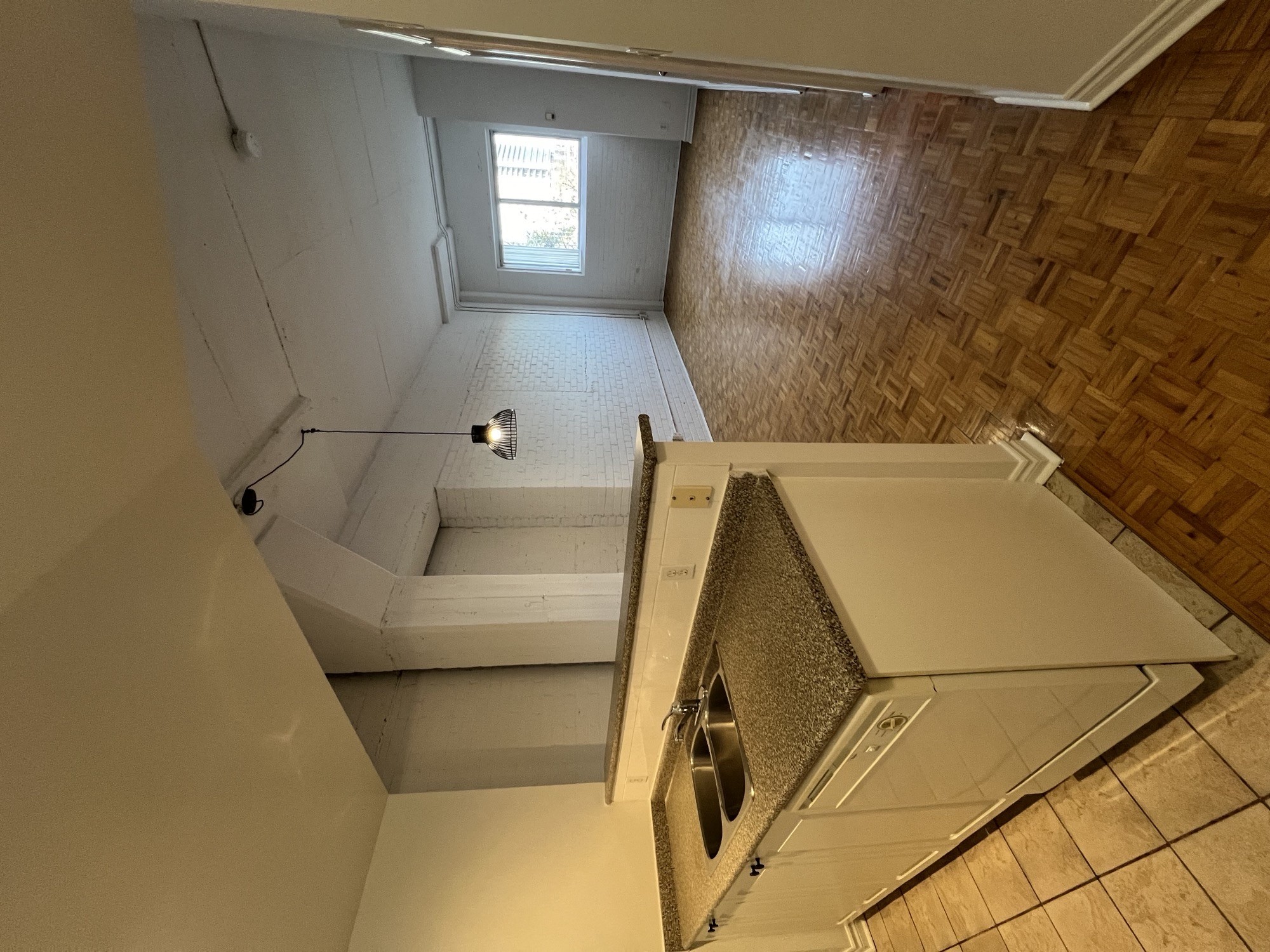 a view of a bathroom from the top of the stairs