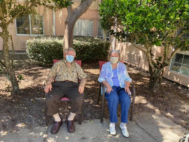 Senior Couple Seating A Garden at Savannah Court of Maitland, Maitland