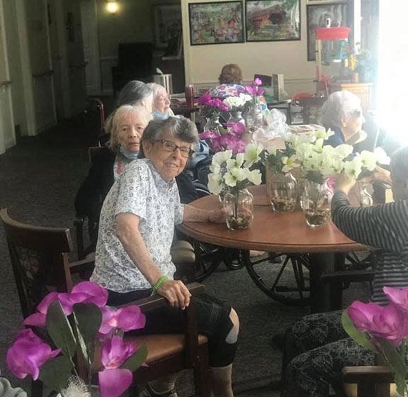 Seniors Seating With Flowers at Savannah Court of Brandon, Florida, 33510