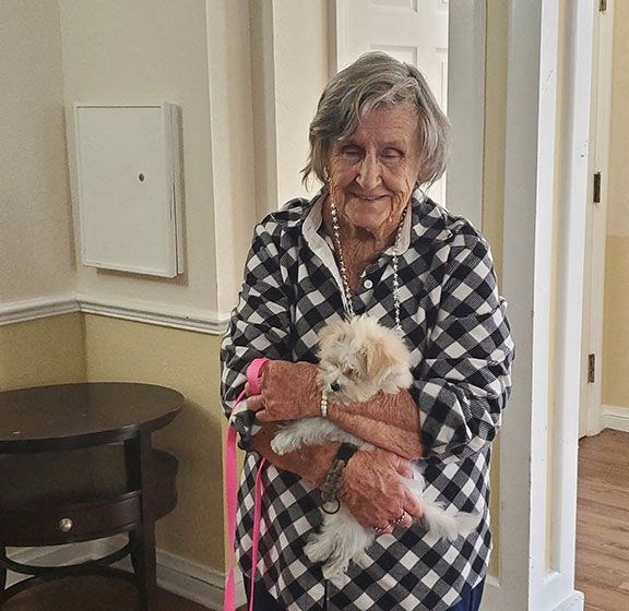 Senior Lady Poses With A Pet at Savannah Cottage of Lakeland, Florida