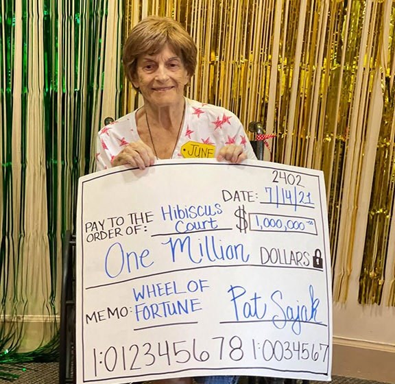 Lady Poses With A Cheque at Hibiscus Court, Melbourne, 32901