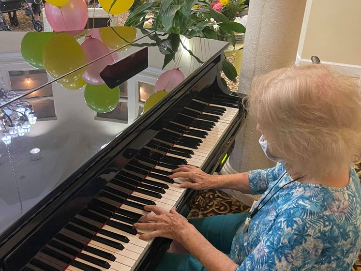 Senior Playing A Piano at Hibiscus Court, Florida