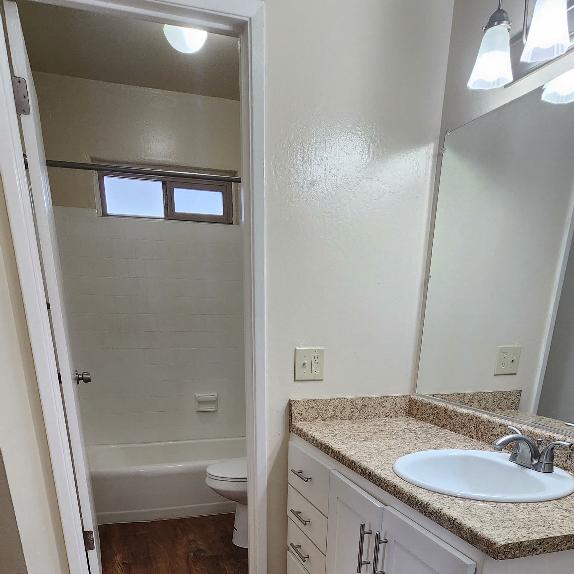a bathroom with a sink and a toilet and a mirror