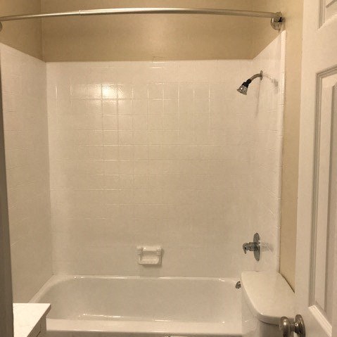 a bathroom with a white bath tub and a sink