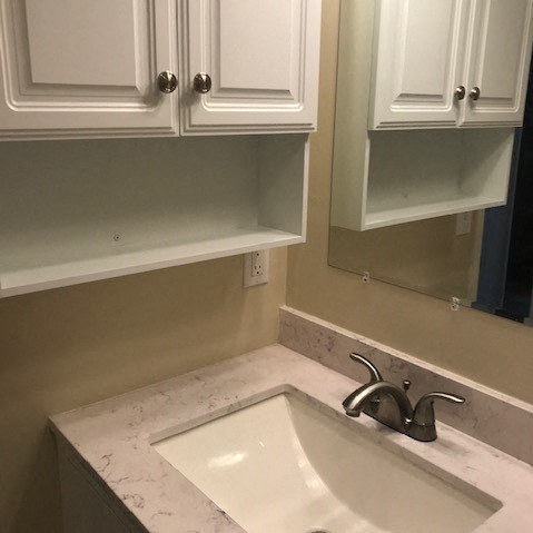 a bathroom with a sink and a mirror