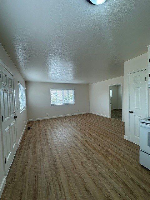 A room with wooden floors and white walls.