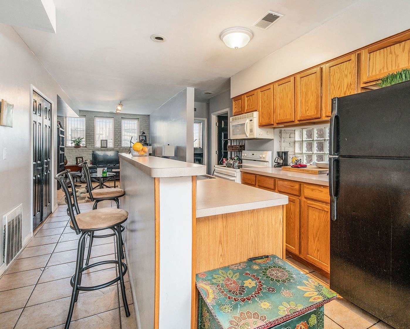 a kitchen with a long counter and stools