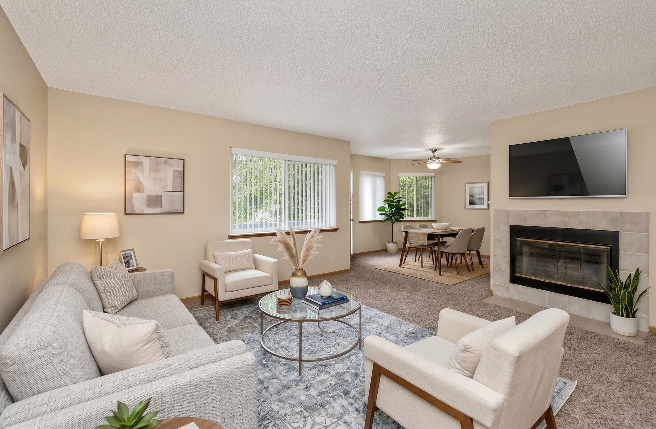 A living room with a grey couch, a coffee table, a fireplace, and a television.