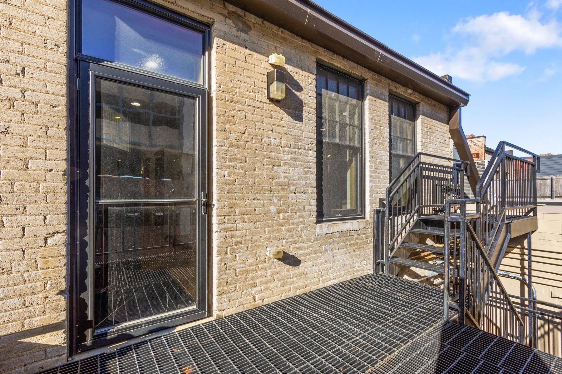 A brick building with a black door and windows.