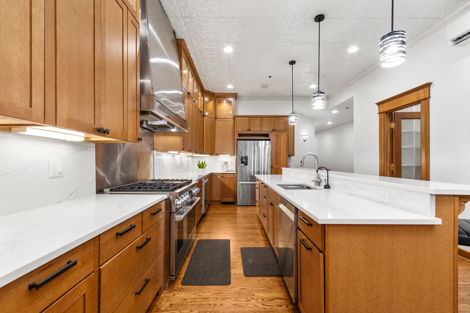 A kitchen with wooden cabinets and a white countertop.