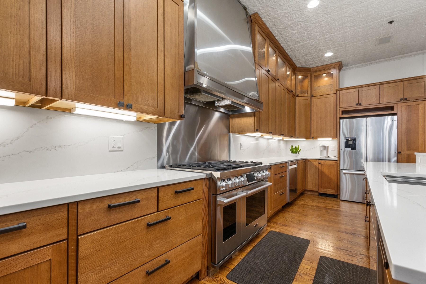 A modern kitchen with wooden cabinets and stainless steel appliances.