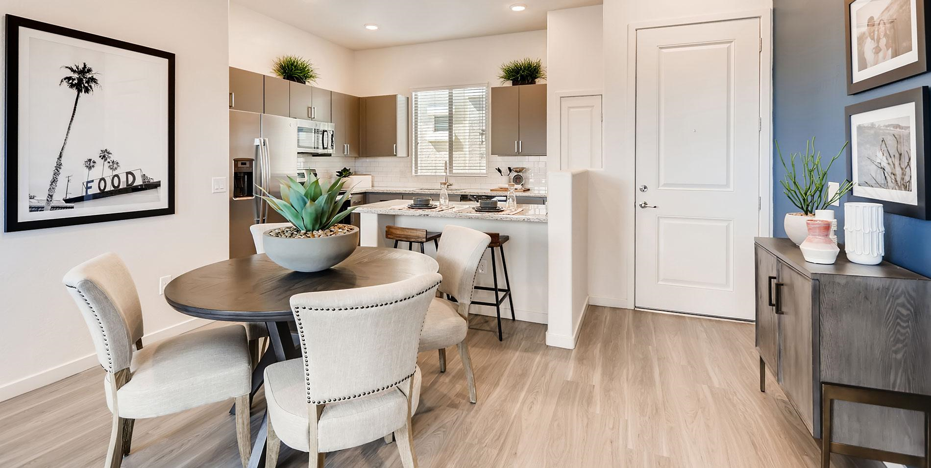 an open concept kitchen and dining area with a table and chairs