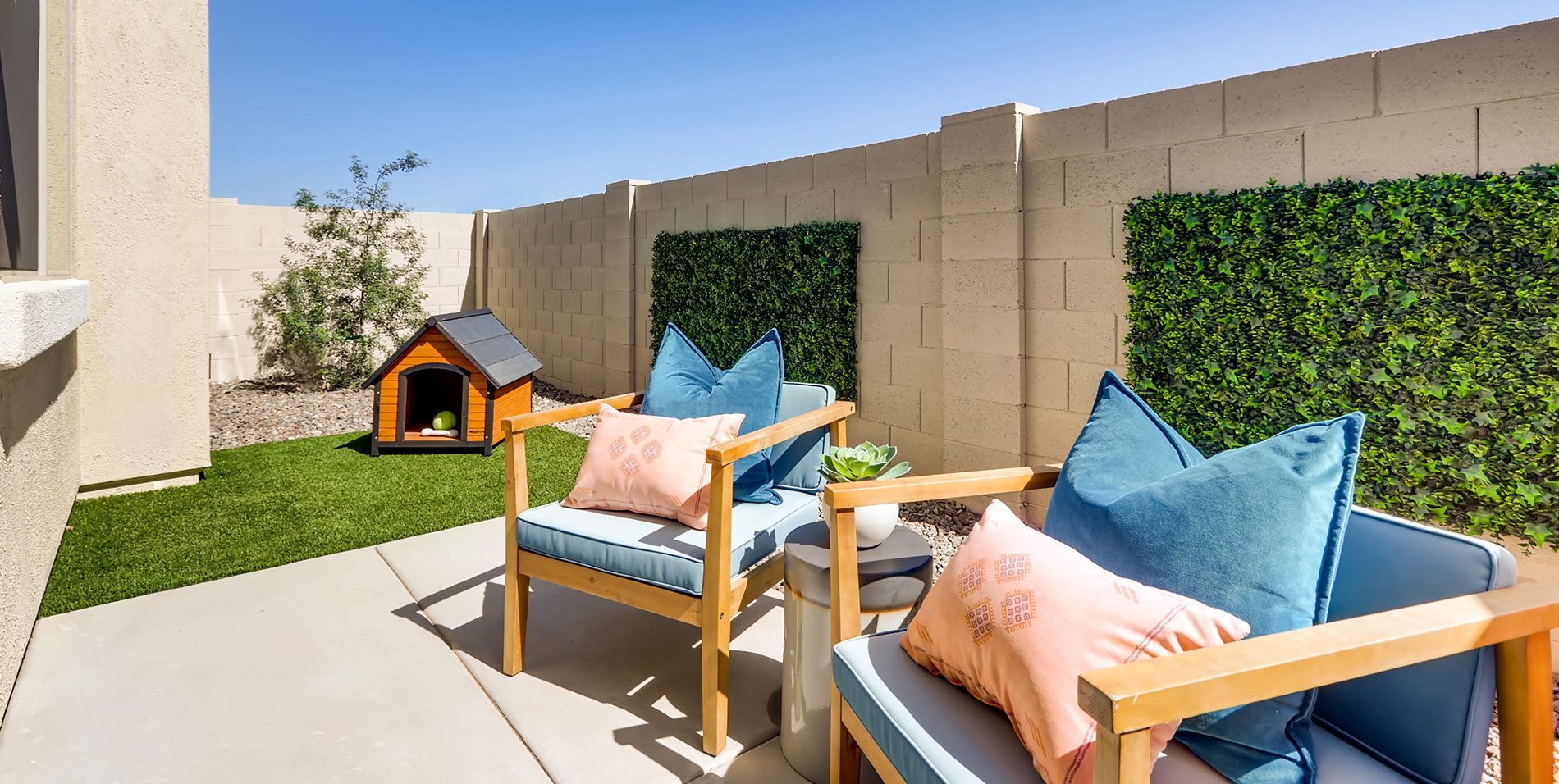 a patio with chairs and a dog house