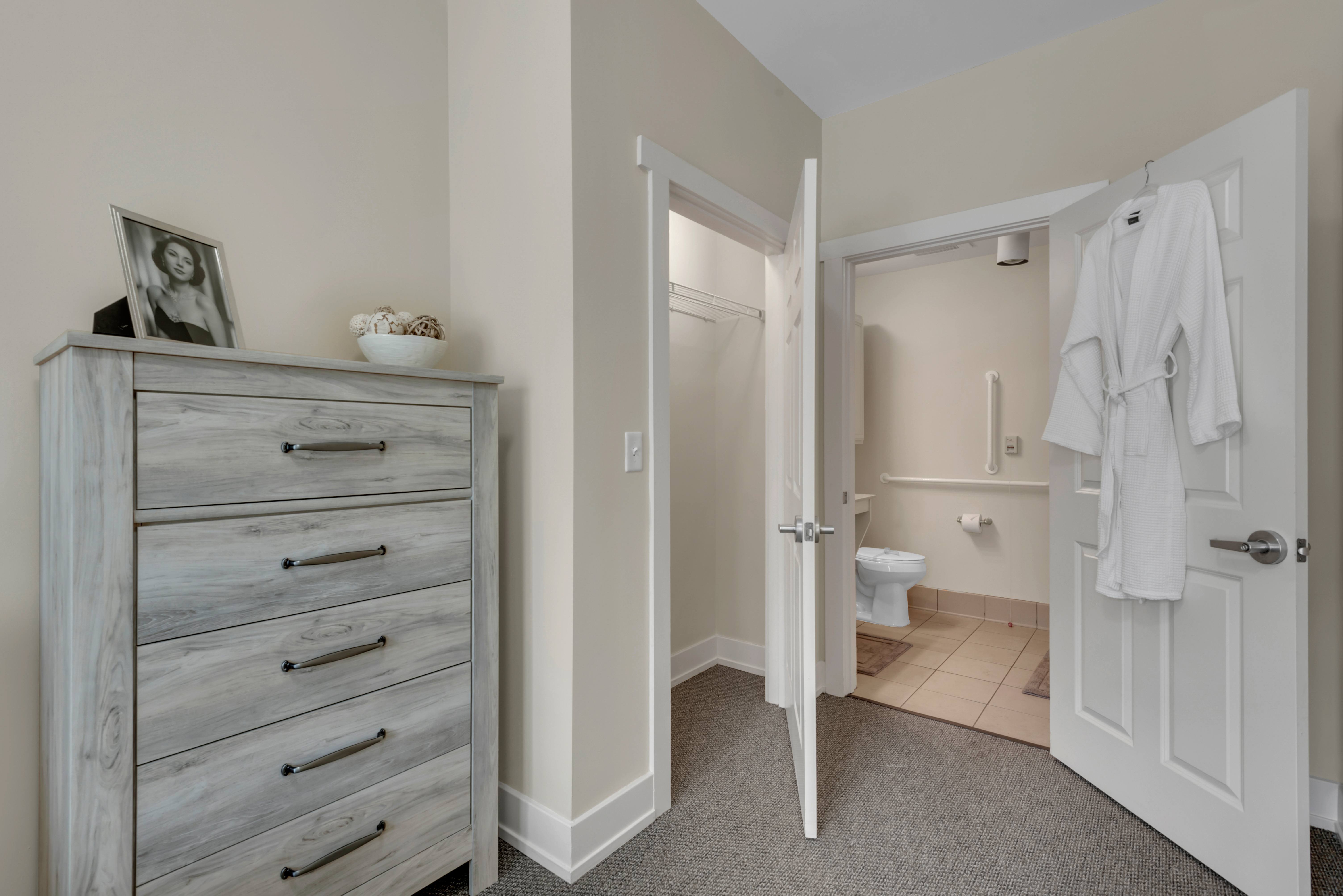 A bathroom with a white door and a white towel hanging on it.at Spring Arbor of Severna Park, Severna Park, Maryland