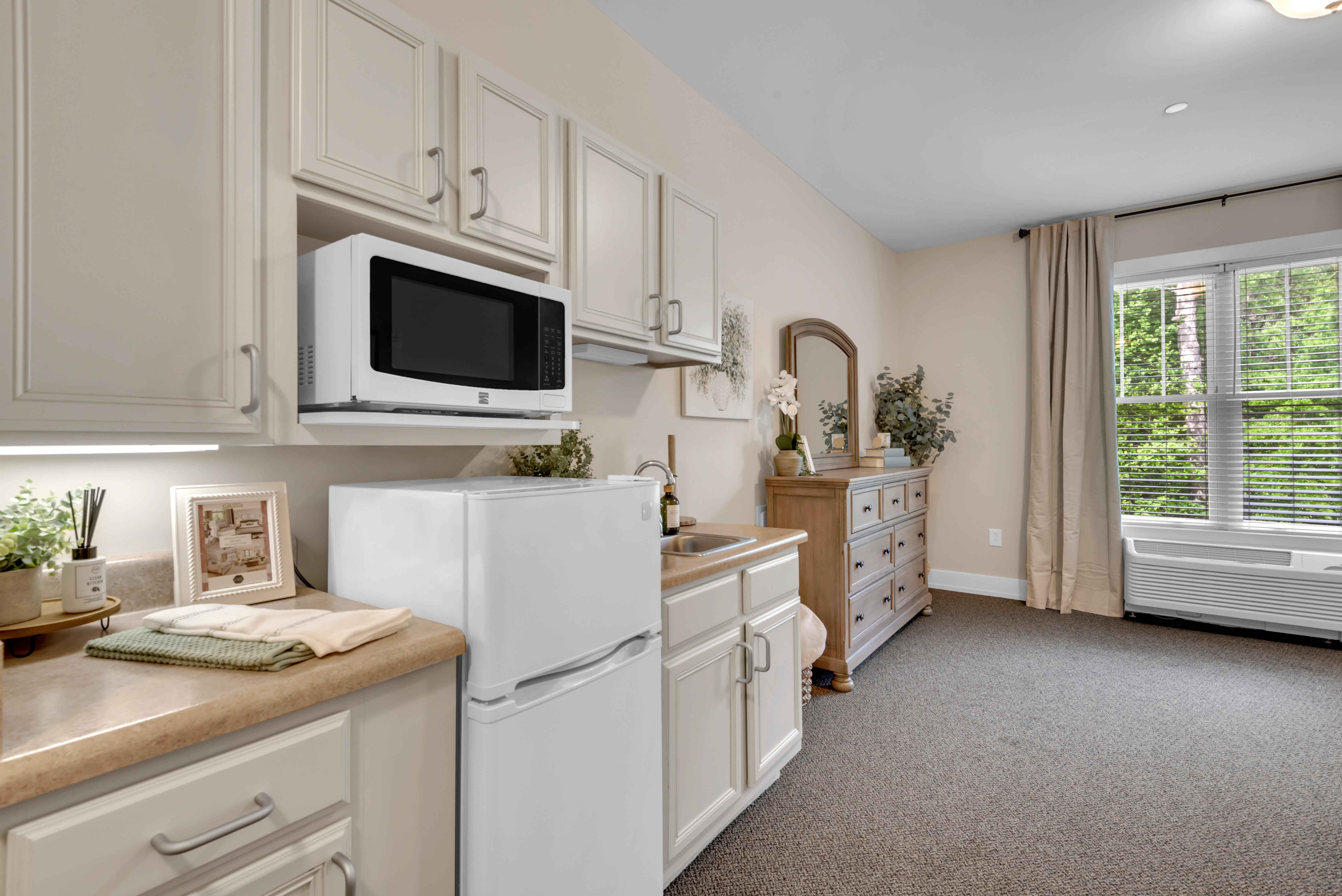A kitchen with white appliances and cabinets.at Spring Arbor of Severna Park, Severna Park, 21146