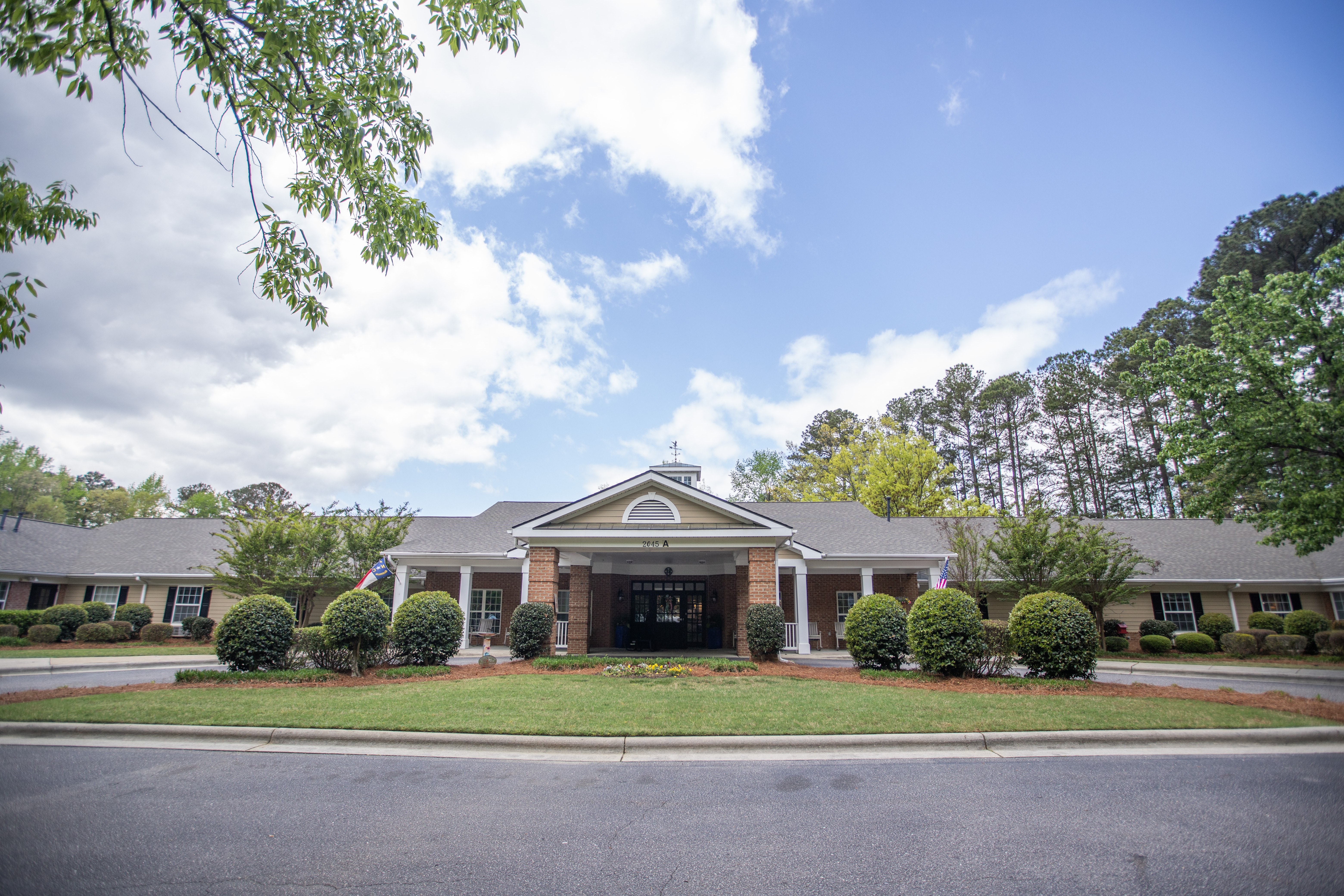 A building with a green lawn in front.at Spring Arbor of Wilson, Wilson