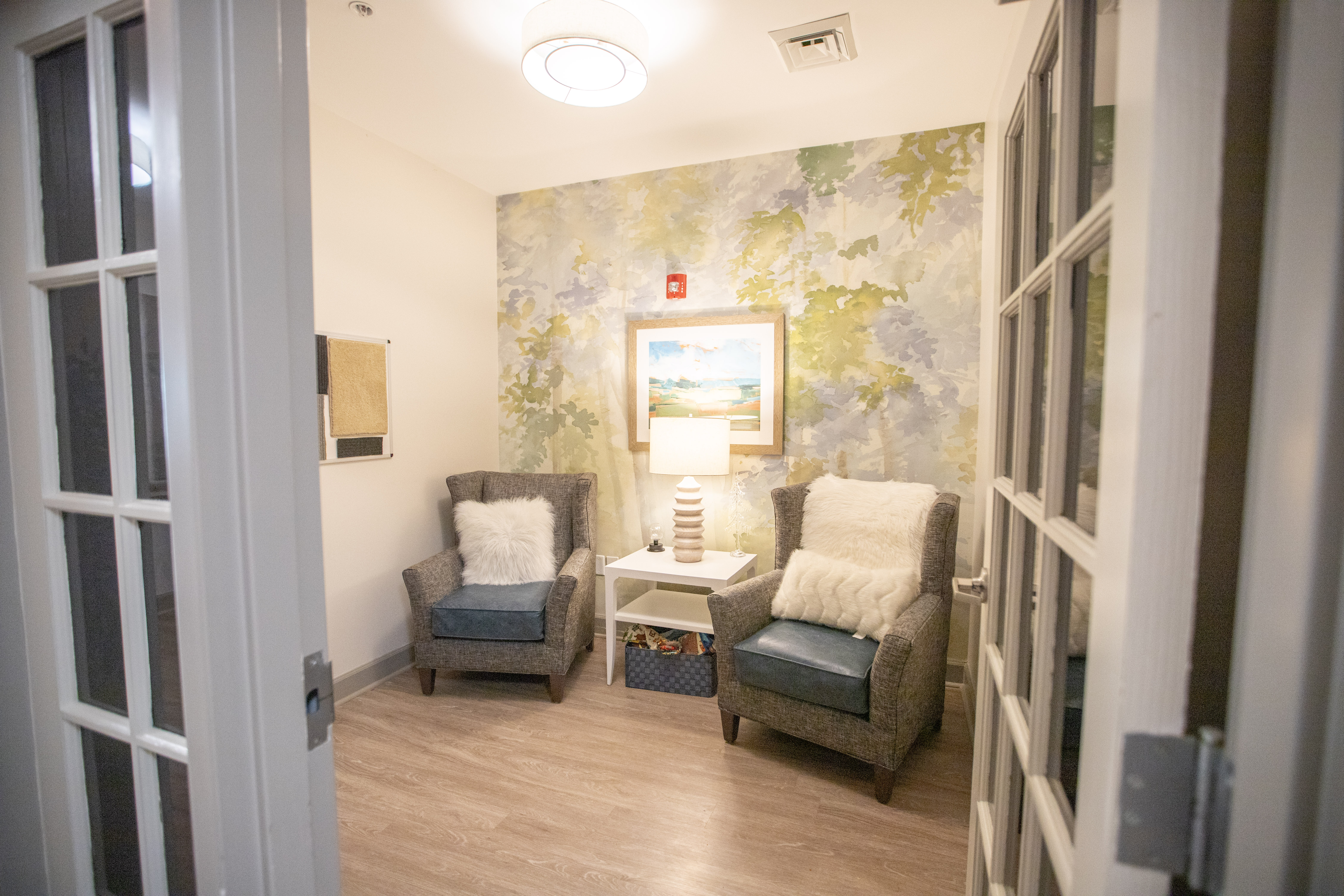 A room with two chairs and a table with a painting on the wall.at Spring Arbor of Wilson, Wilson, NC 27893-2873