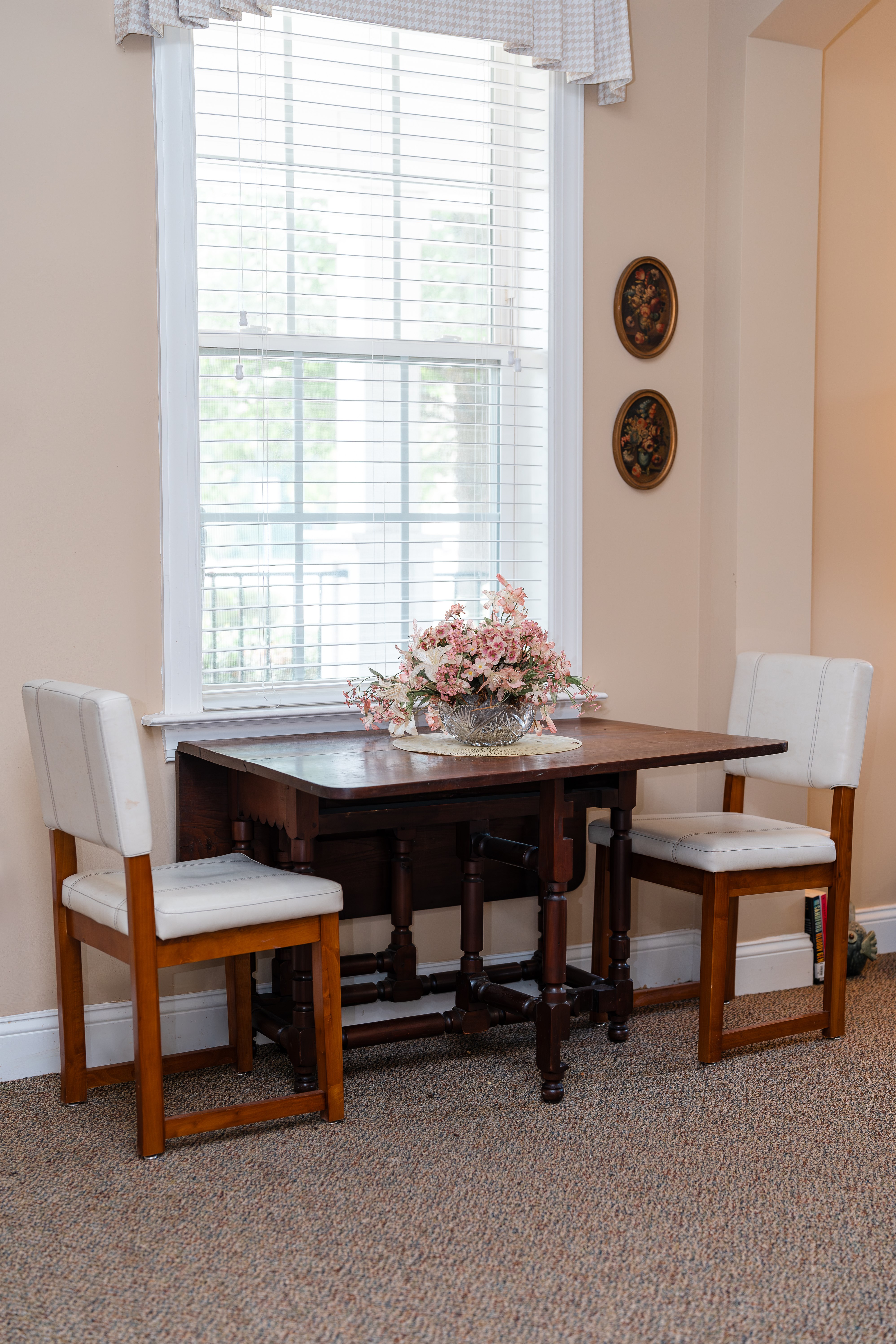 A dining room with a table and chairs at Spring Arbor of Cary in Cary, NC
