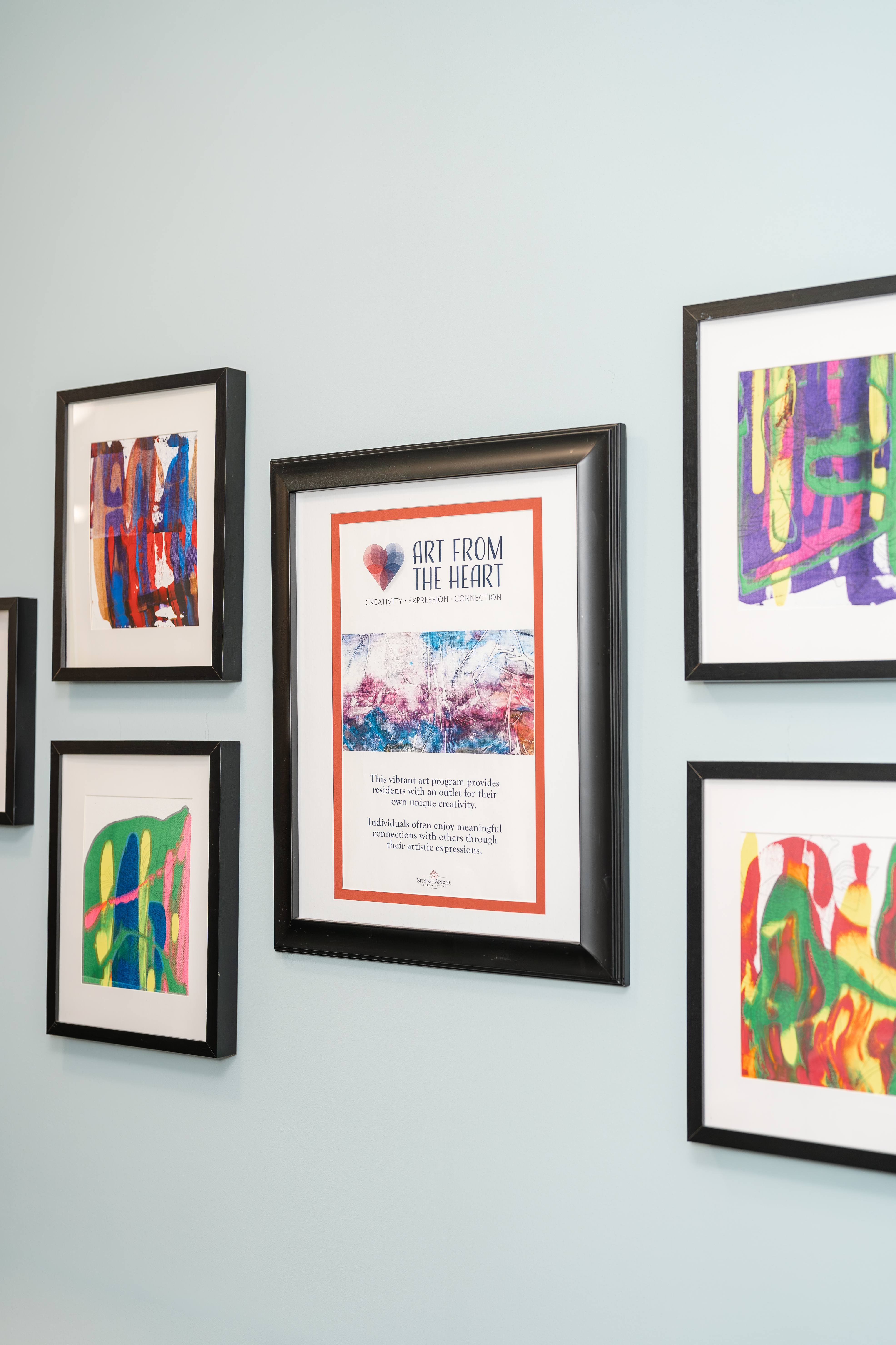 A wall with framed artwork at Spring Arbor of Cary in Cary, NC