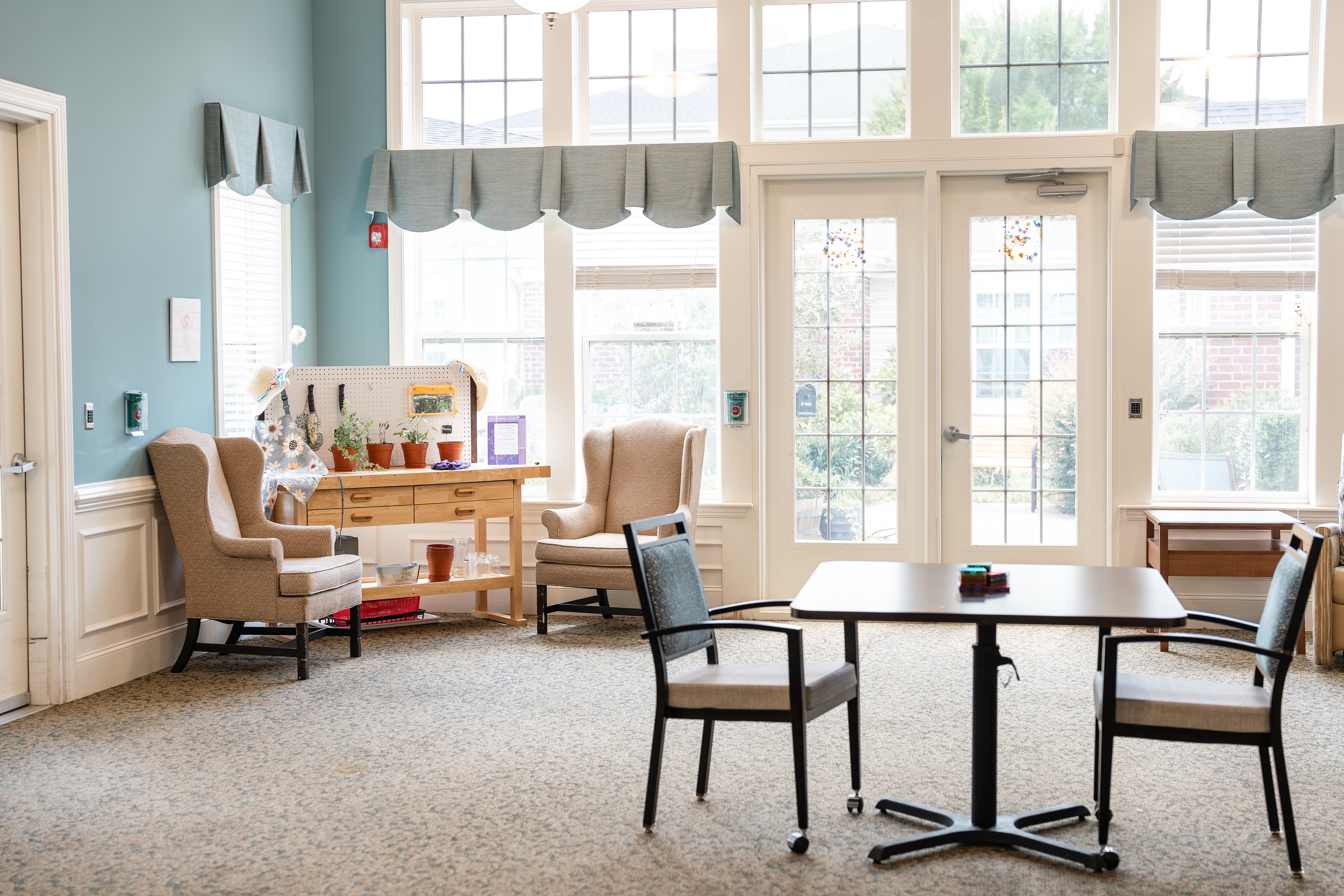 A room with a table and chairs in front of a window at Spring Arbor of Cary in Cary, NC