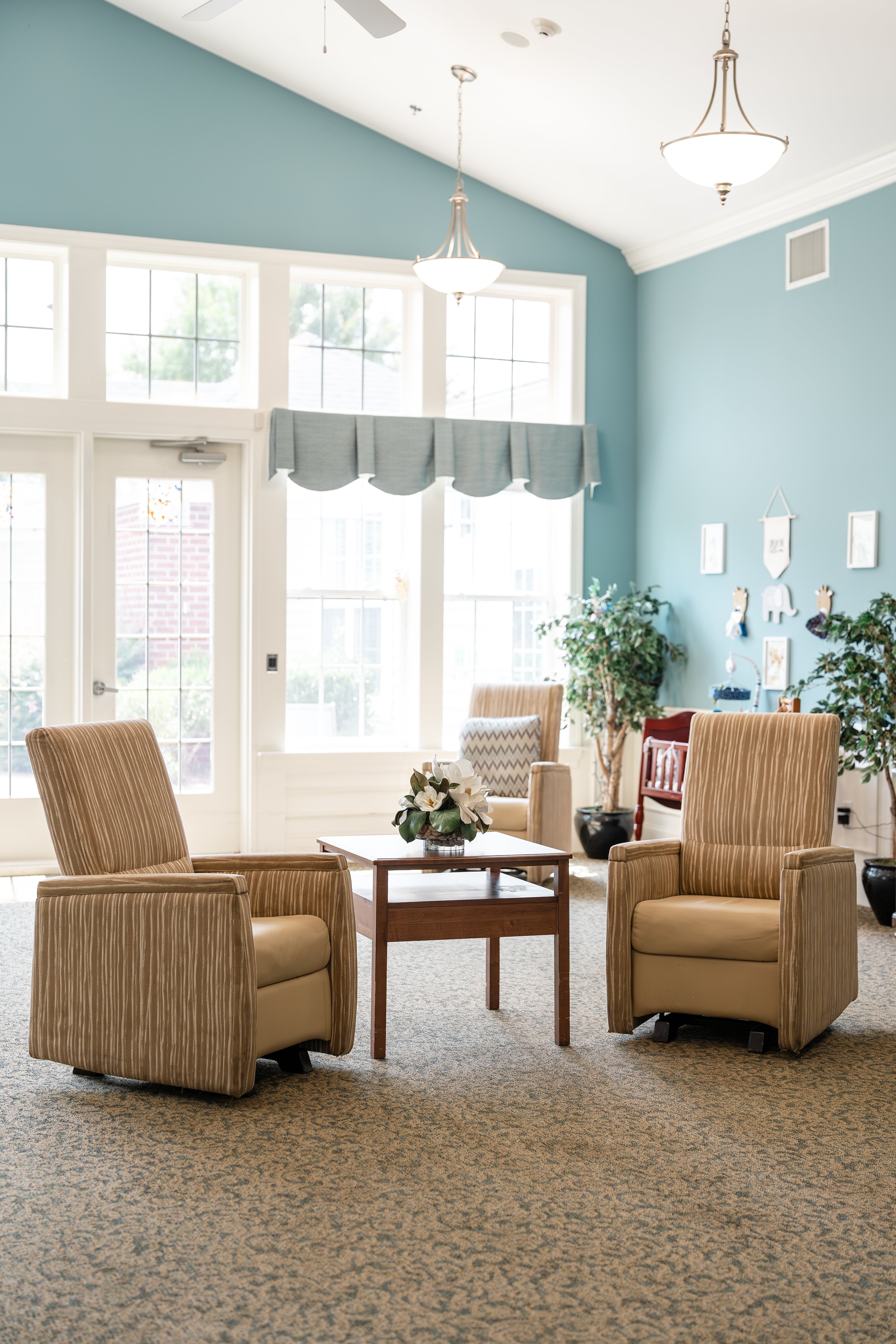 Two chairs and a table are in a room with a window at Spring Arbor of Cary in Cary, NC