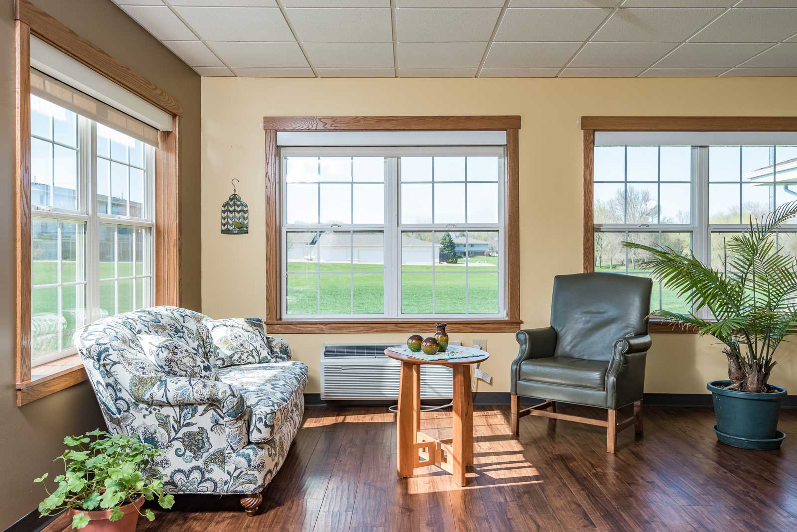 A living room with a couch, chair, and table.at Windsor Manor Webster City, Webster City