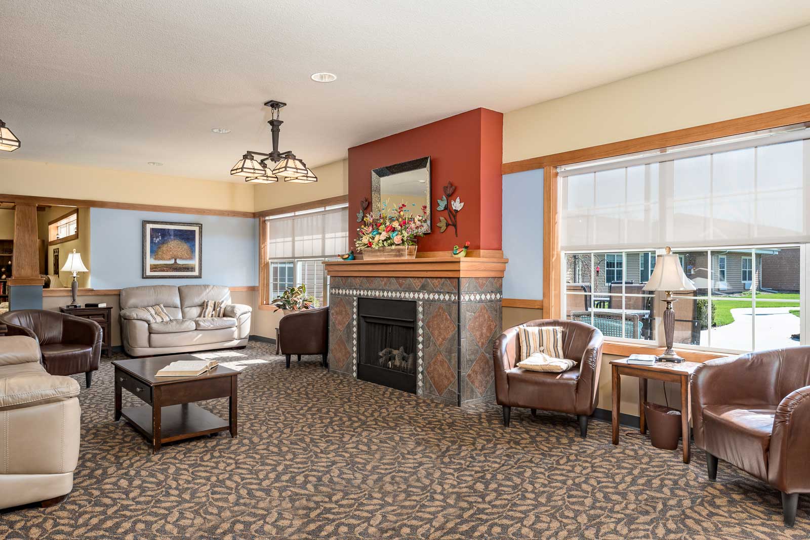 A living room with a fireplace at Windsor Manor Indianola, Indianola, IA