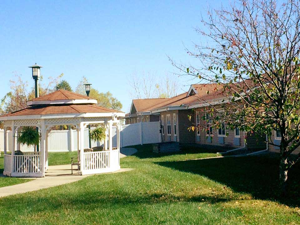 A gazebo is in the middle of a grassy area at Windsor Manor Indianola, Indianola, IA