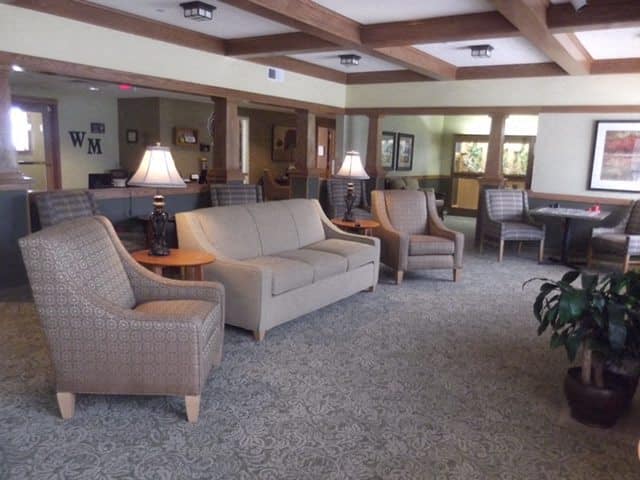 A living room with a couch, chair, and table  at Windsor Manor Nevada, Nevada, IA