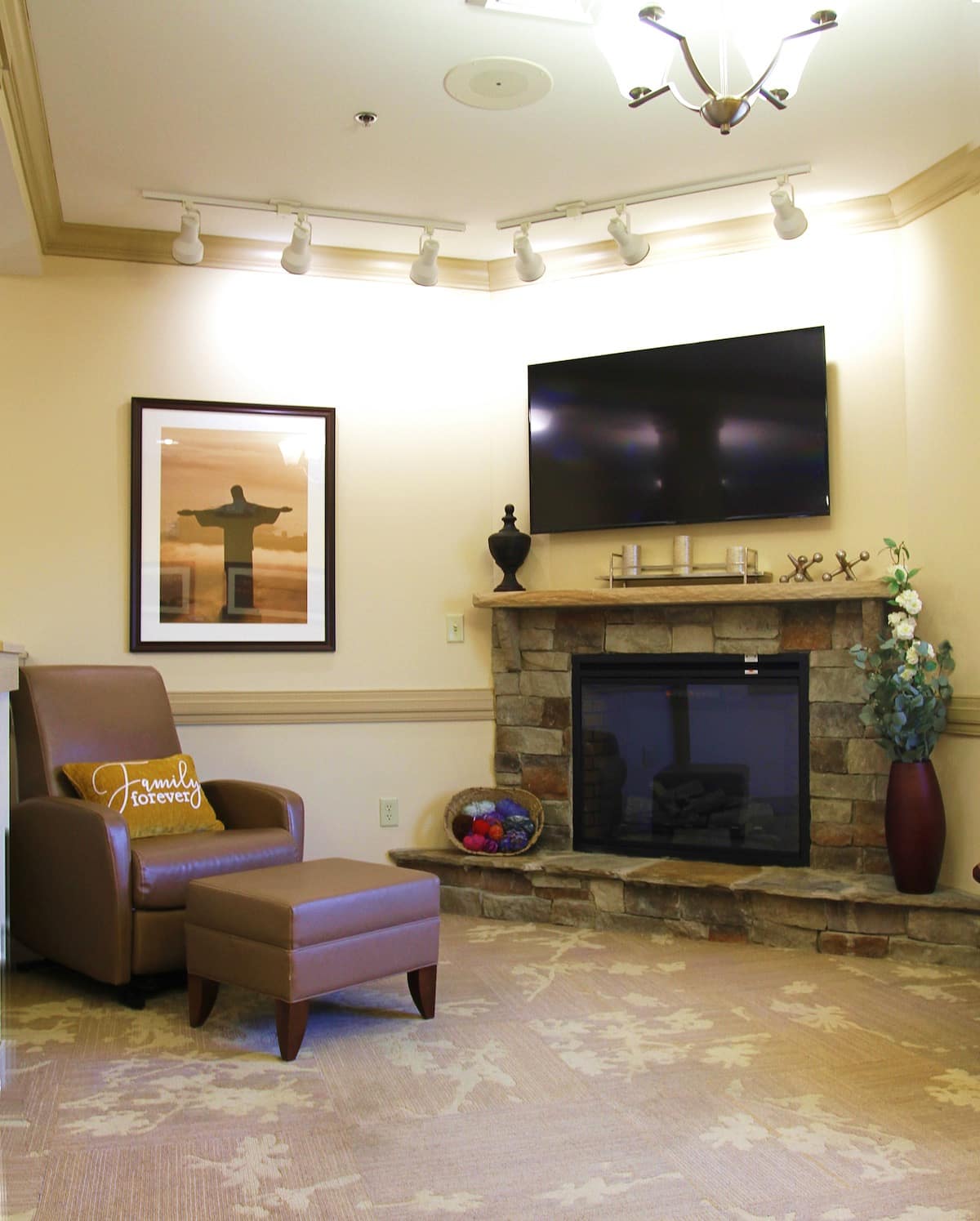 A living room with a fireplace and a television.at Spring Arbor of Sandhills, Raeford, NC 28376