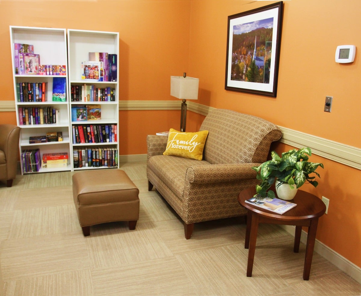 Seating Room With Books Shelf at Spring Arbor of Sandhills, North Carolina