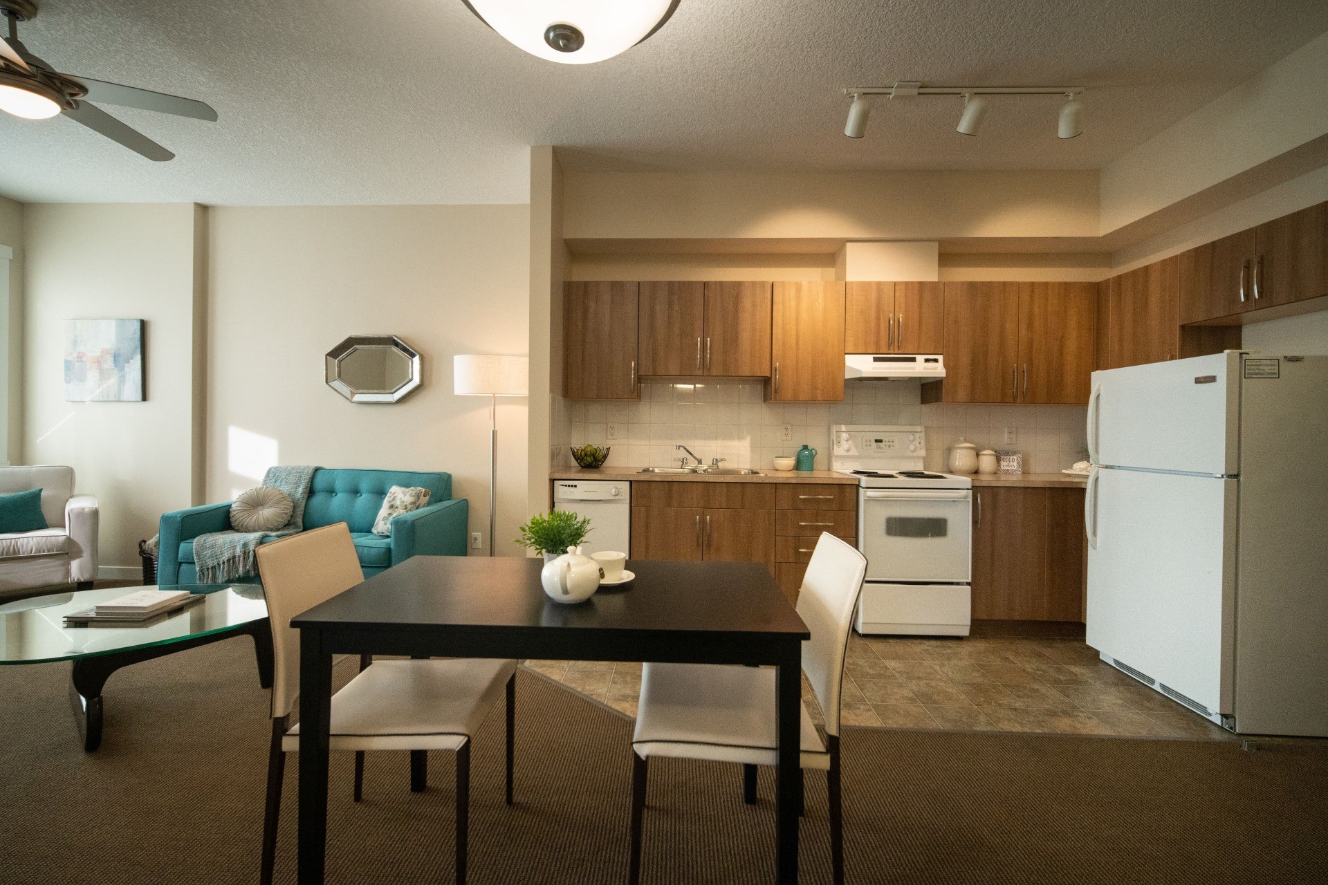 Full kitchens and dining areas in apartments at Willow Park on the Bow in Bridgeland