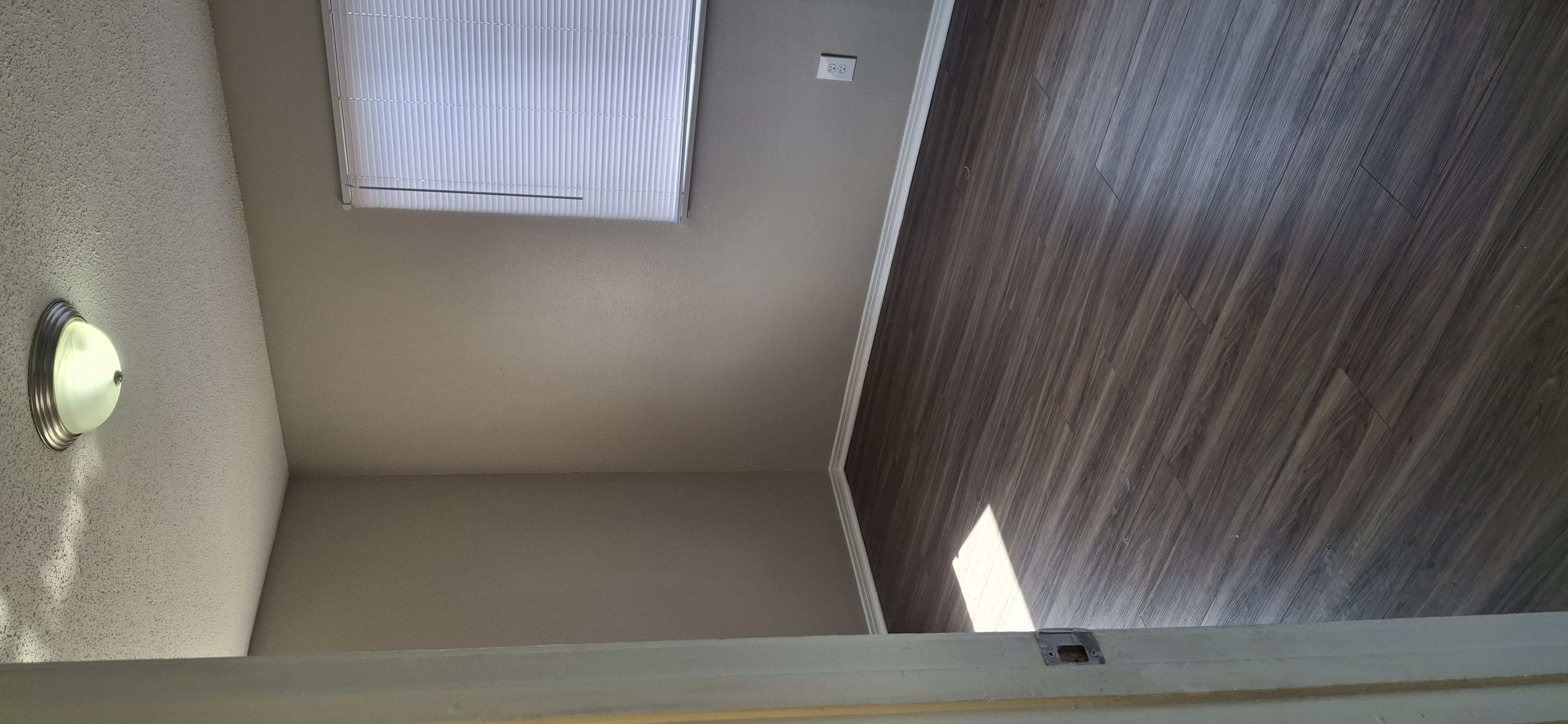 A small window with blinds is on the wall.