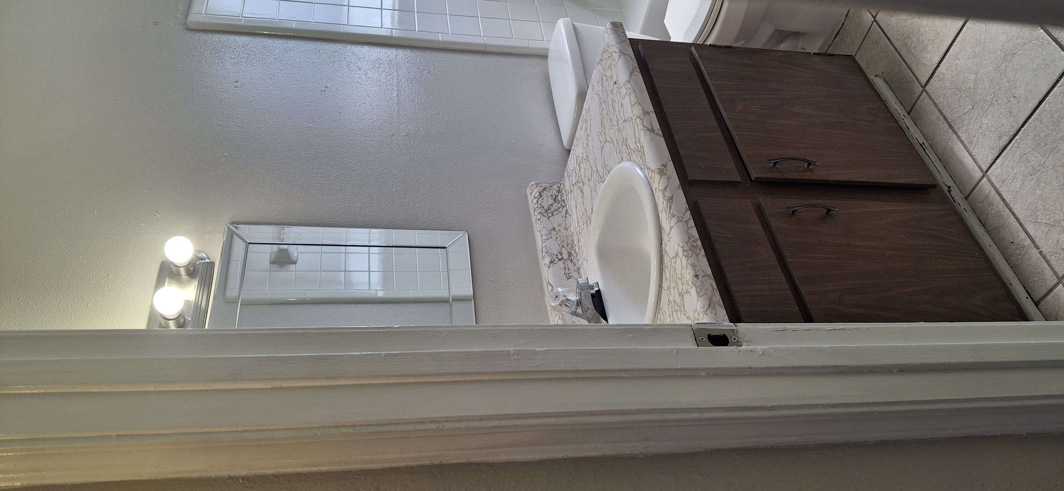 A bathroom with a toilet and sink.