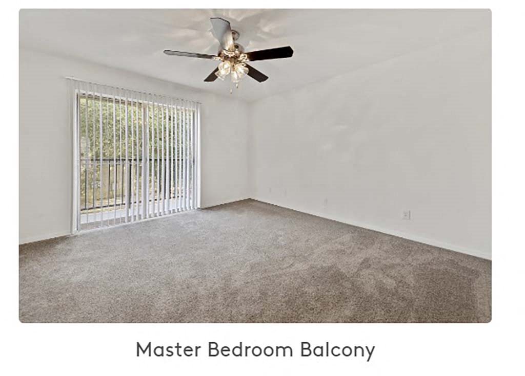 a bedroom with a ceiling fan and a window