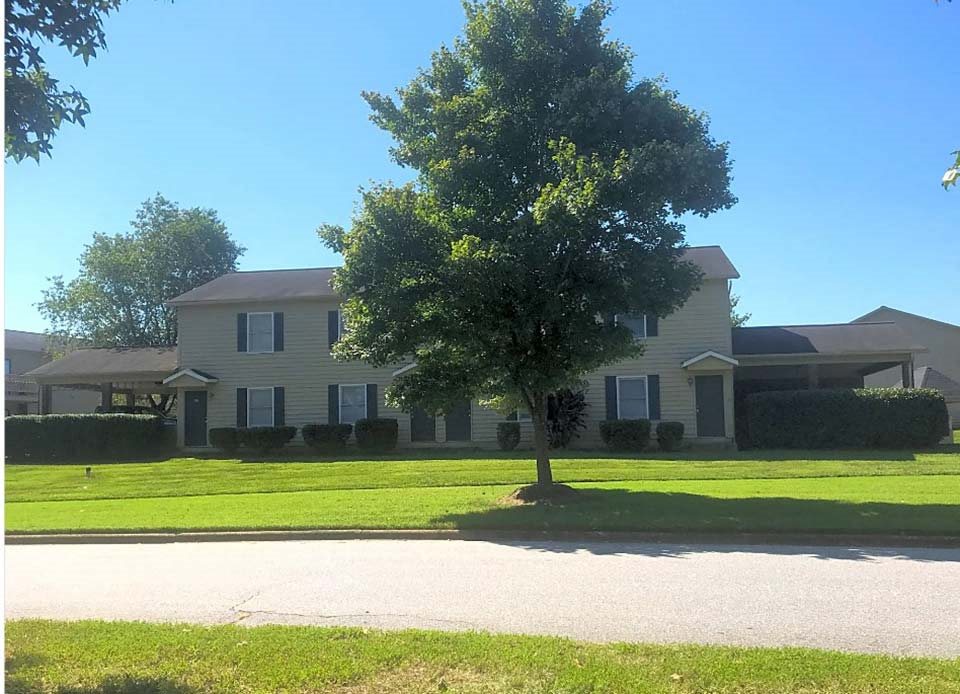 a house with a tree in front of it