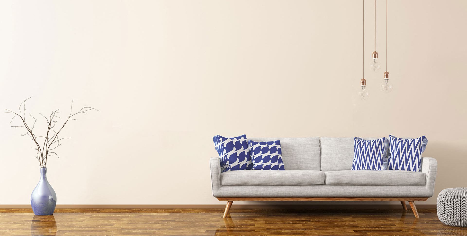 a couch with blue and white pillows in a living room