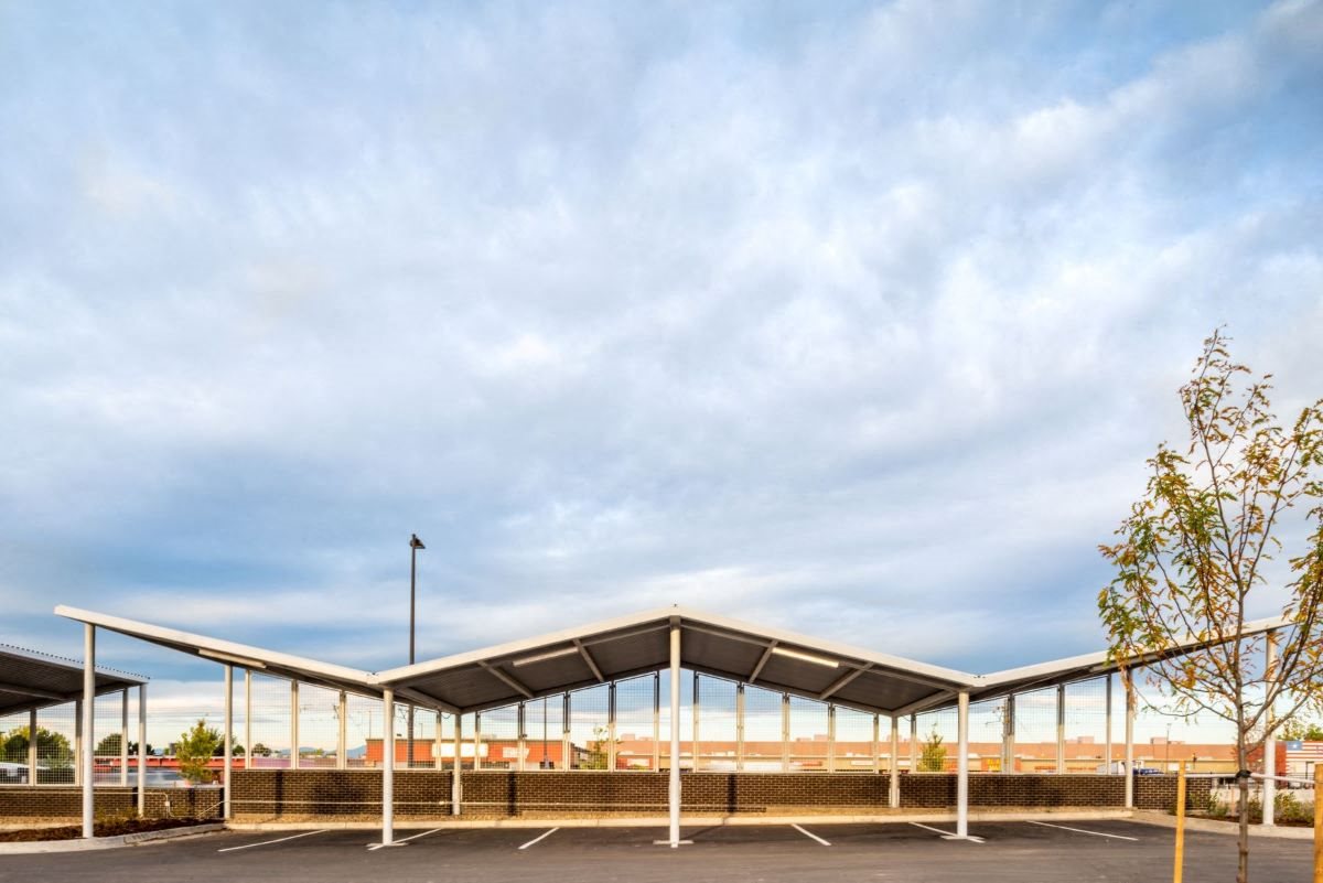 Angular covered parking structure that covers 8 parking spots
