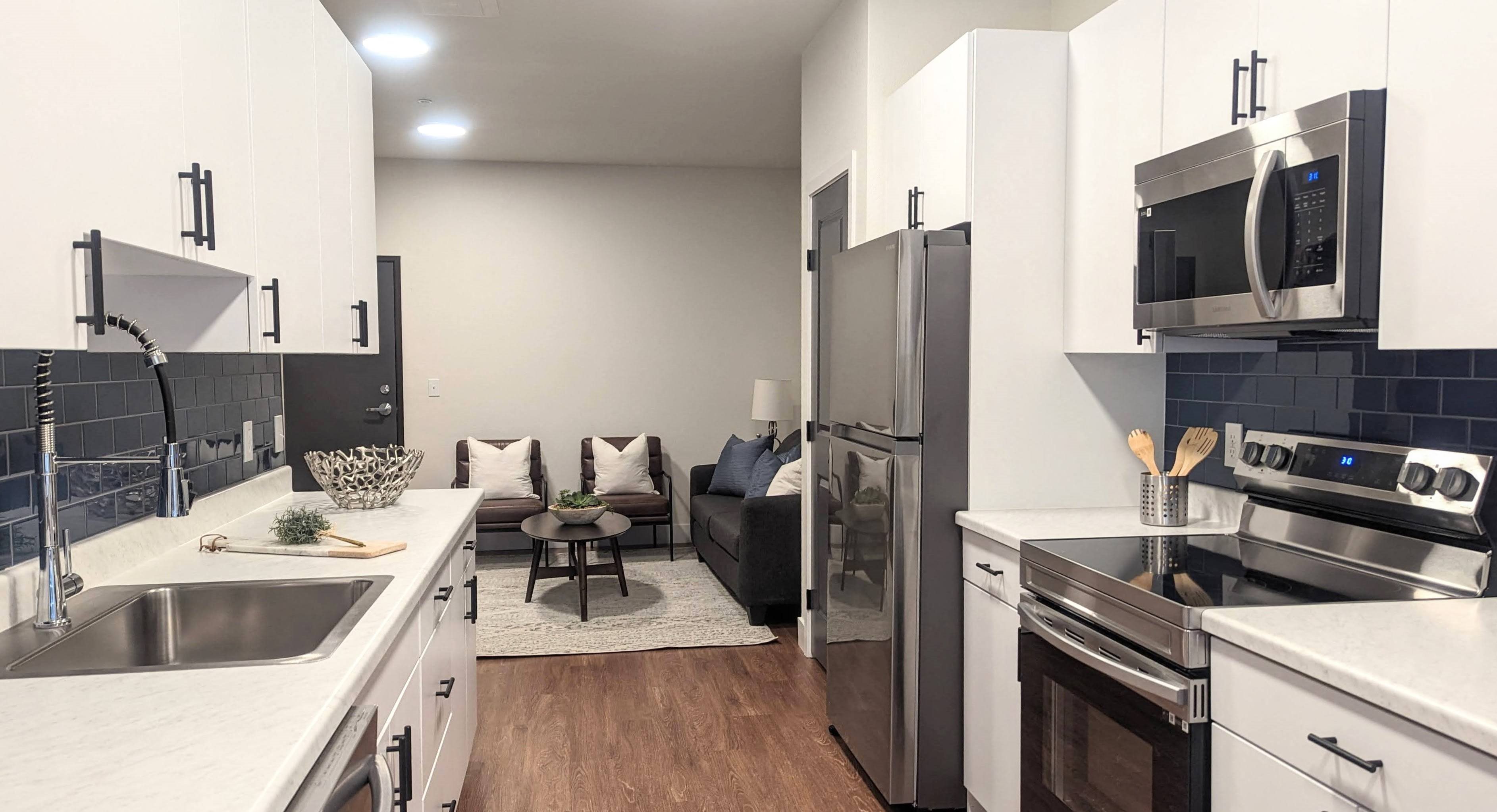 View from the back window into kitchen showing stainless steel appliances.