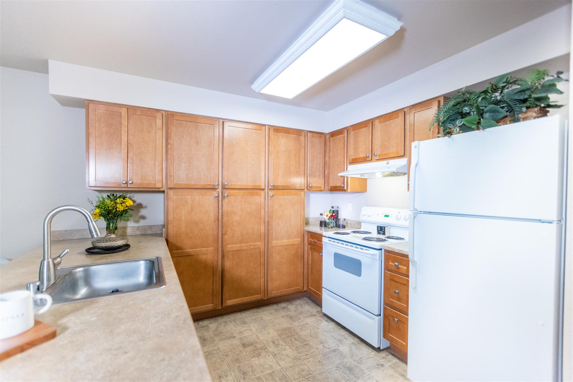 Kitchen cabinets and fridge at Cogir of Queen Anne, Seattle, 98109
