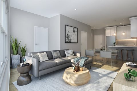 A modern living room with a grey sofa and a wooden coffee table.
