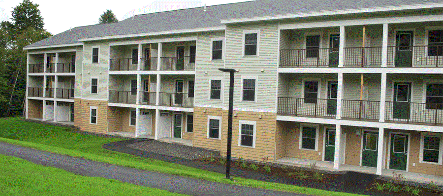Apartment building with green doors and windows.,Apartment building with green doors and windows.